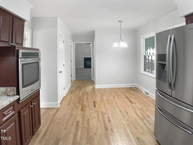 4601 Pemberton Dr, Raleigh, NC 27609 - kitchen featuring stainless steel appliances, a chandelier, light wood-type flooring, and decorative light fixtures