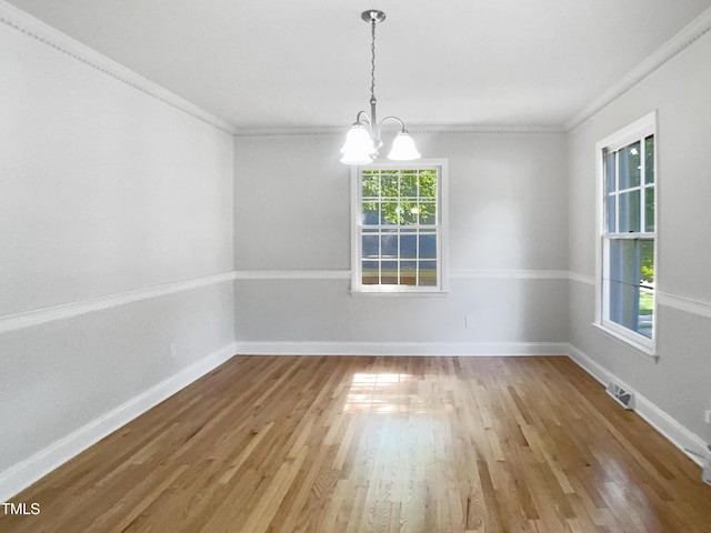 4601 Pemberton Dr, Raleigh, NC 27609 - unfurnished room featuring ornamental molding, a chandelier, and wood finished floors