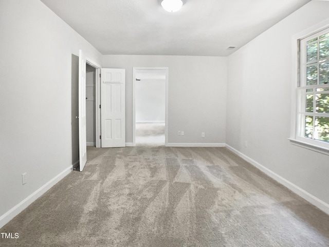4601 Pemberton Dr, Raleigh, NC 27609 - unfurnished bedroom featuring carpet flooring and a walk in closet