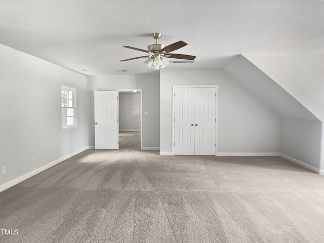 4601 Pemberton Dr, Raleigh, NC 27609 - bonus room with carpet floors, a ceiling fan, a textured ceiling, and vaulted ceiling