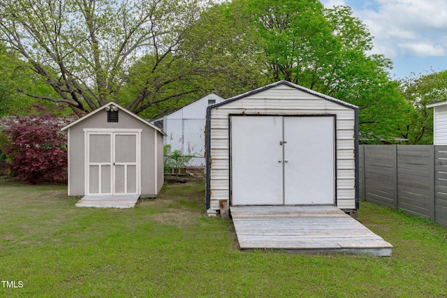 view of shed featuring fence