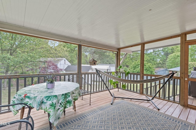 sunroom / solarium featuring outdoor dining area