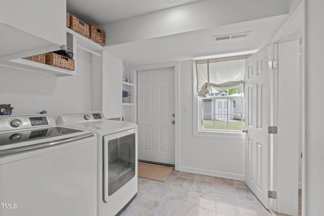 laundry room featuring laundry area, baseboards, washing machine and dryer, and visible vents