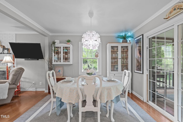 dining room featuring plenty of natural light, wood finished floors, and a chandelier