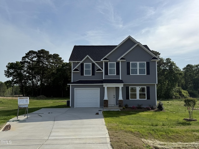craftsman inspired home featuring a front lawn, driveway, roof with shingles, and a garage
