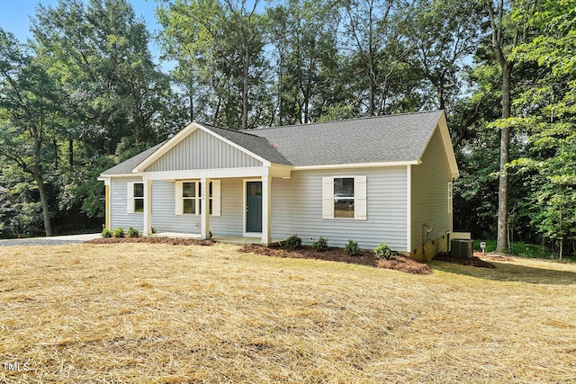 5500 Lake Wendell Rd, Zebulon, NC 27597 - view of front of house featuring covered porch, board and batten siding, a shingled roof, and a front yard