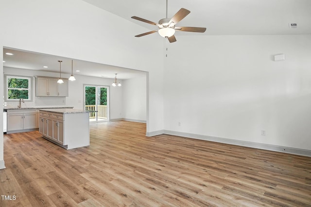 5500 Lake Wendell Rd, Zebulon, NC 27597 - kitchen with light wood-style floors, a ceiling fan, open floor plan, recessed lighting, and a kitchen island