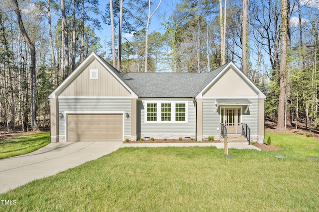 view of front facade featuring an attached garage, a shingled roof, a front lawn, and concrete driveway