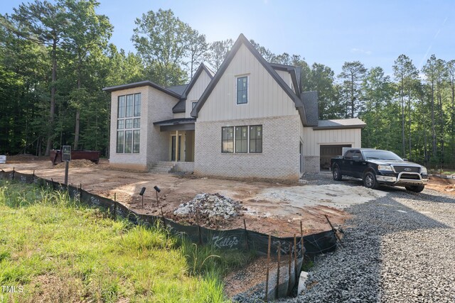 2957 Wexford Pond Way, Wake Forest, NC 27587 - back of property with brick siding, board and batten siding, and a shingled roof