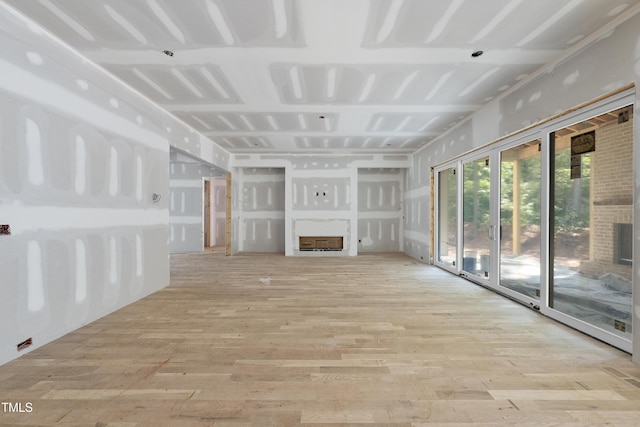 2957 Wexford Pond Way, Wake Forest, NC 27587 - unfurnished living room featuring a fireplace and light wood-style floors