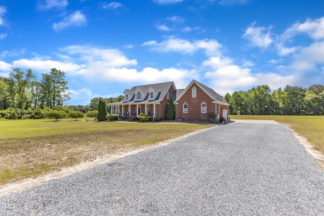 5595 Godwin Lake Rd, Benson, NC 27504 - cape cod home featuring brick siding, a front lawn, and gravel driveway