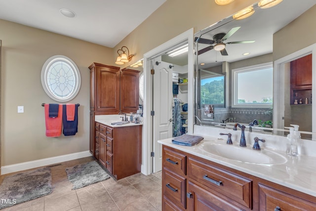 5595 Godwin Lake Rd, Benson, NC 27504 - full bath featuring vanity, visible vents, baseboards, ceiling fan, and a spacious closet
