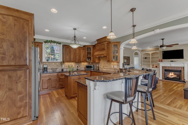 5595 Godwin Lake Rd, Benson, NC 27504 - kitchen with open floor plan, ceiling fan, brown cabinets, and freestanding refrigerator