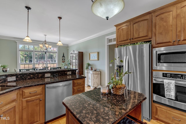 5595 Godwin Lake Rd, Benson, NC 27504 - kitchen featuring crown molding, brown cabinetry, stainless steel appliances, and a chandelier