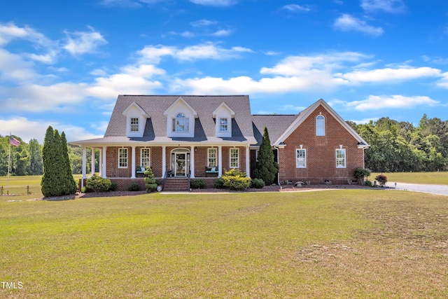 5595 Godwin Lake Rd, Benson, NC 27504 - view of front of home featuring covered porch, a front yard, and brick siding