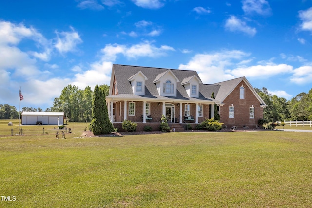 5595 Godwin Lake Rd, Benson, NC 27504 - cape cod-style house featuring a porch, brick siding, fence, and a front lawn
