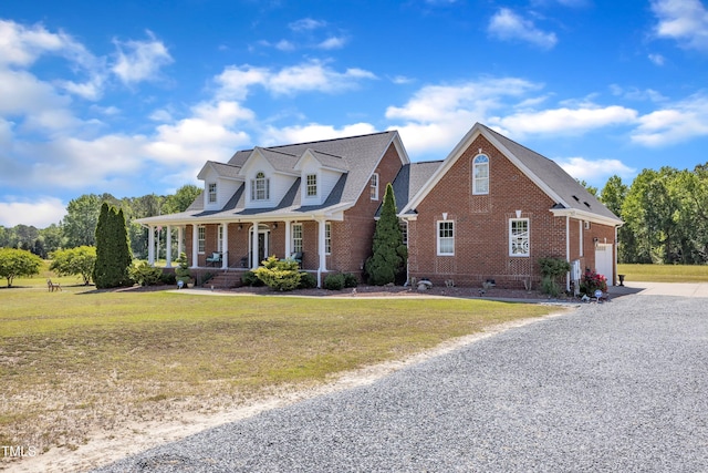 5595 Godwin Lake Rd, Benson, NC 27504 - cape cod house with concrete driveway, brick siding, a front yard, and a porch