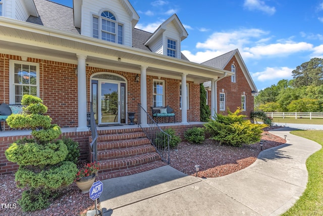 5595 Godwin Lake Rd, Benson, NC 27504 - entrance to property featuring brick siding, a shingled roof, fence, and a porch