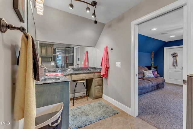 5595 Godwin Lake Rd, Benson, NC 27504 - ensuite bathroom with connected bathroom, tile patterned flooring, vanity, baseboards, and vaulted ceiling