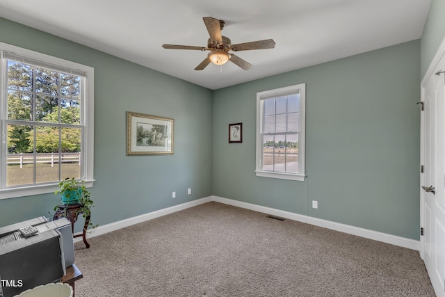 5595 Godwin Lake Rd, Benson, NC 27504 - carpeted spare room with visible vents, a ceiling fan, and baseboards