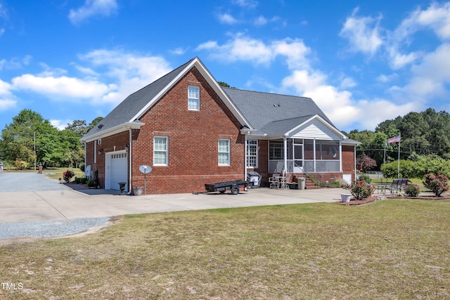 5595 Godwin Lake Rd, Benson, NC 27504 - rear view of property with brick siding, a garage, a sunroom, a lawn, and driveway