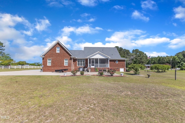 5595 Godwin Lake Rd, Benson, NC 27504 - view of front of property with fence, a front lawn, brick siding, a sunroom, and a patio