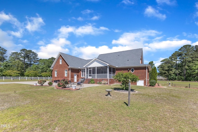 5595 Godwin Lake Rd, Benson, NC 27504 - back of property featuring a lawn, a sunroom, a patio area, and brick siding