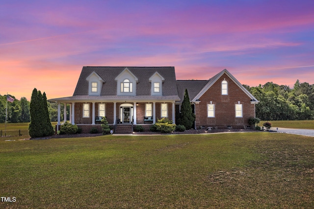 5595 Godwin Lake Rd, Benson, NC 27504 - view of front facade featuring covered porch, a front lawn, and brick siding