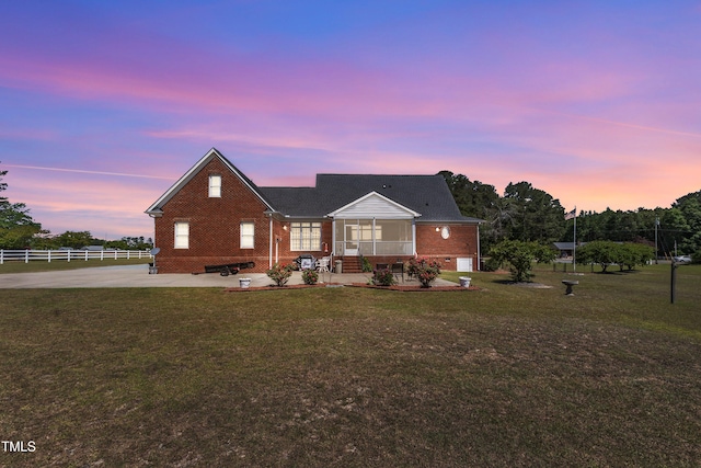 5595 Godwin Lake Rd, Benson, NC 27504 - view of front of home with a lawn, brick siding, fence, and a patio