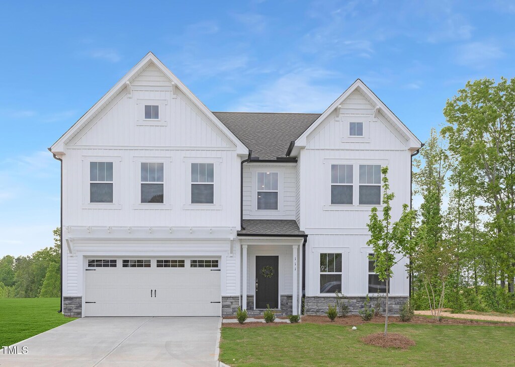 111 Silver Moon Ln Unit 121, Clayton, NC 27527 - view of front of house with a front yard, a shingled roof, and board and batten siding