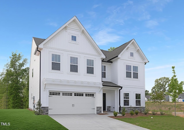 111 Silver Moon Ln Unit 121, Clayton, NC 27527 - view of front of house featuring a front yard, a garage, stone siding, board and batten siding, and concrete driveway