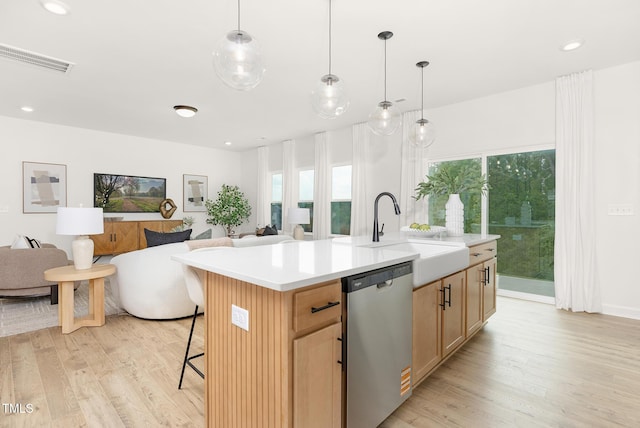 111 Silver Moon Ln Unit 121, Clayton, NC 27527 - kitchen featuring light wood finished floors, a sink, visible vents, stainless steel dishwasher, and open floor plan