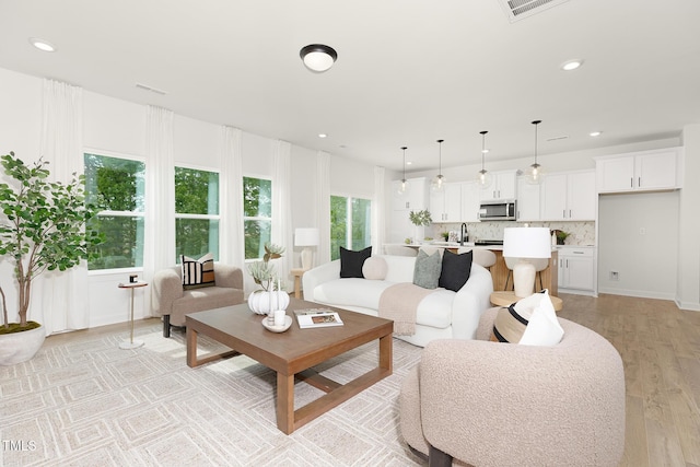 111 Silver Moon Ln Unit 121, Clayton, NC 27527 - living room with visible vents, recessed lighting, and light wood-style flooring