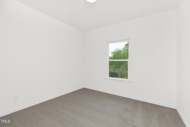 111 Silver Moon Ln Unit 121, Clayton, NC 27527 - spare room with baseboards and dark colored carpet