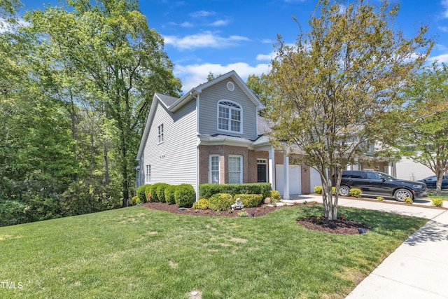 9005 River Estates Dr, Knightdale, NC 27545 - traditional-style home with a garage, concrete driveway, brick siding, and a front yard