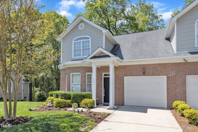 9005 River Estates Dr, Knightdale, NC 27545 - traditional-style home featuring roof with shingles, a front yard, brick siding, concrete driveway, and an attached garage