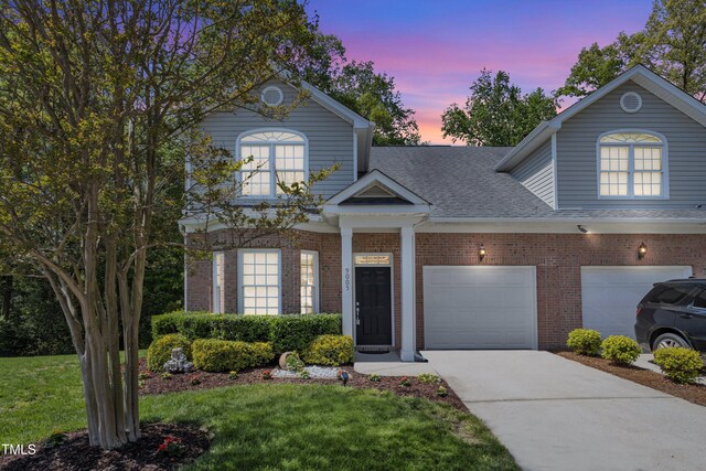 9005 River Estates Dr, Knightdale, NC 27545 - traditional-style home featuring concrete driveway, brick siding, a shingled roof, and a front yard