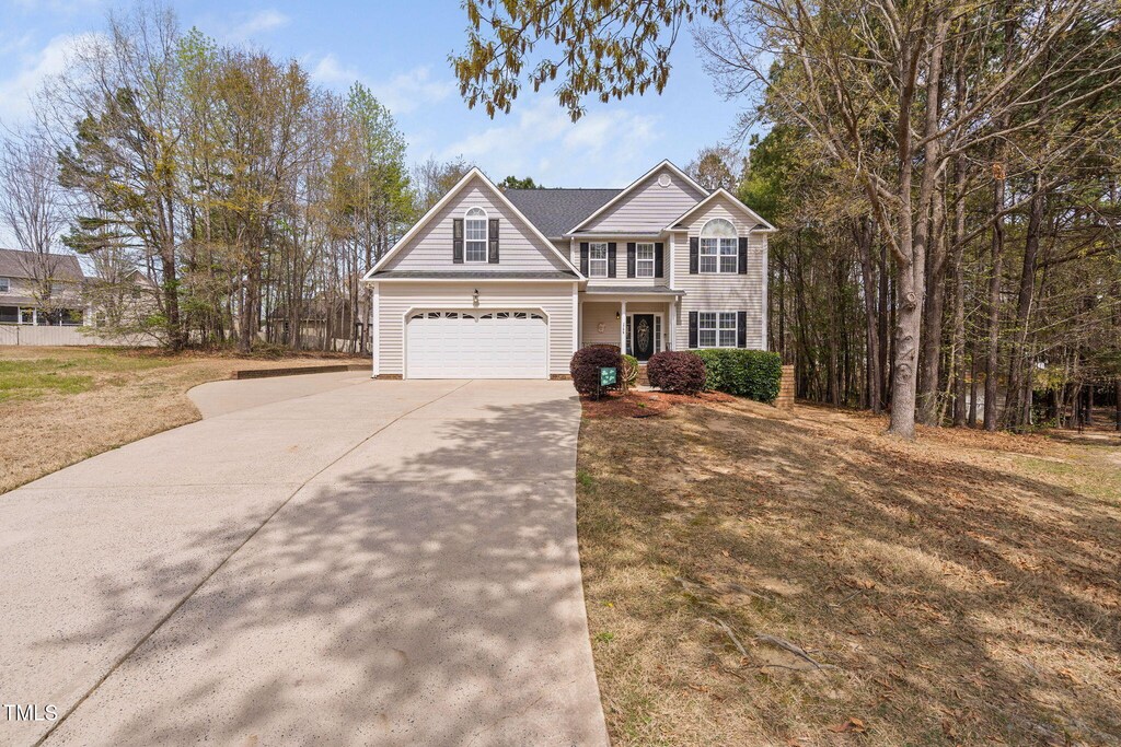traditional home with concrete driveway