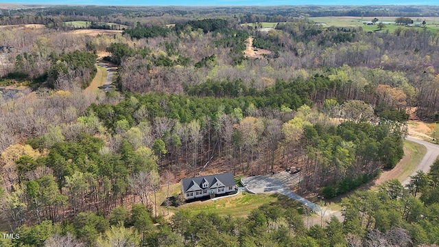 birds eye view of property with a wooded view