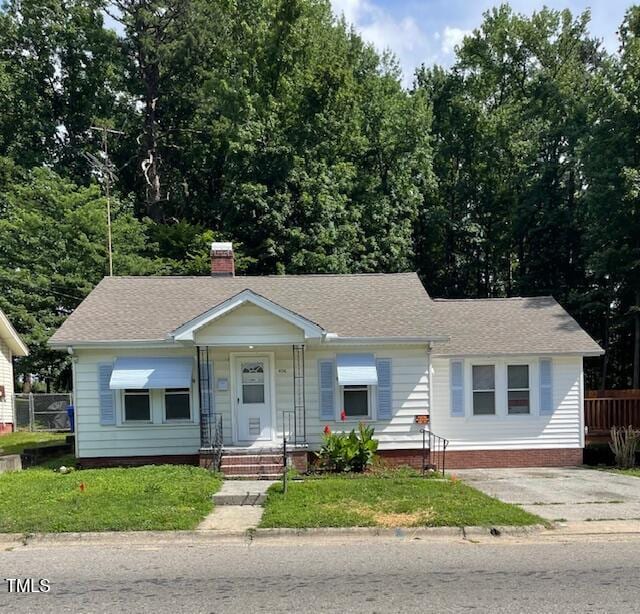 906 Camden Ave, Durham, NC 27701 - view of front of property featuring a shingled roof, concrete driveway, and a chimney