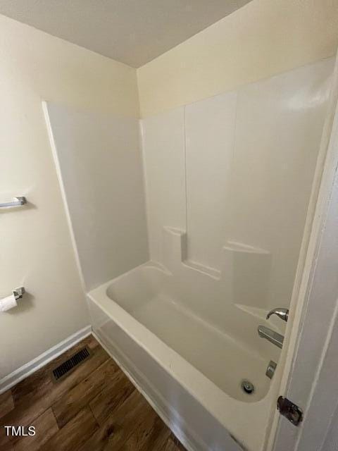 906 Camden Ave, Durham, NC 27701 - bathroom with wood finished floors and shower / tub combination