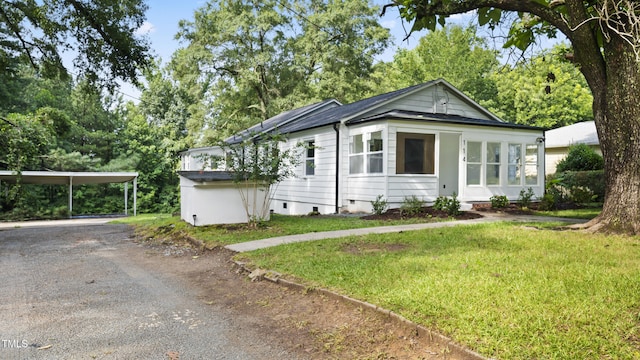 114 Barnhill St, Durham, NC 27707 - view of front of house featuring dirt driveway, a front yard, and a detached carport