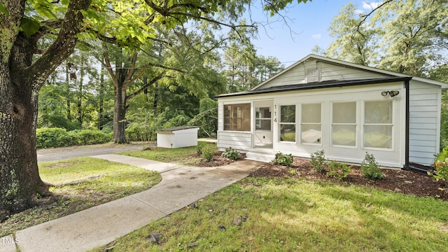 114 Barnhill St, Durham, NC 27707 - view of front facade featuring a sunroom and a front lawn