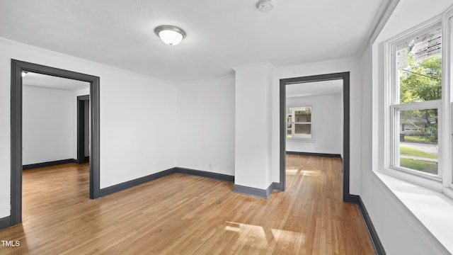 114 Barnhill St, Durham, NC 27707 - spare room with a smoke detector, light wood-type flooring, and crown molding