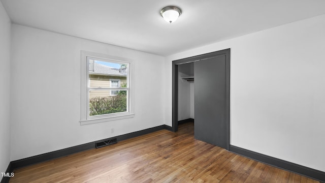 114 Barnhill St, Durham, NC 27707 - unfurnished bedroom featuring hardwood / wood-style flooring and a closet