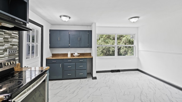 114 Barnhill St, Durham, NC 27707 - kitchen featuring stainless steel appliances, light marble finish flooring, dark countertops, and blue cabinets