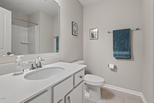 full bath featuring toilet, tile patterned floors, vanity, and baseboards