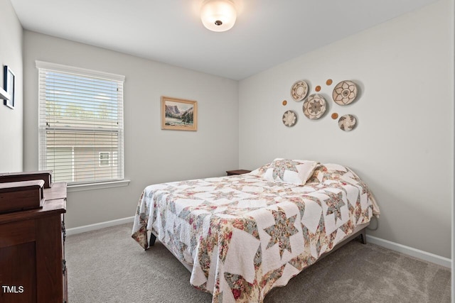 bedroom with carpet floors and baseboards