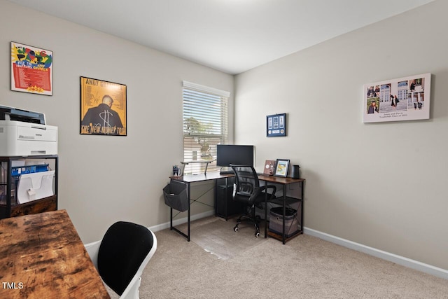 carpeted home office featuring baseboards