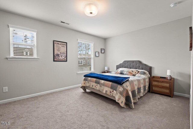 bedroom with carpet flooring, baseboards, and visible vents